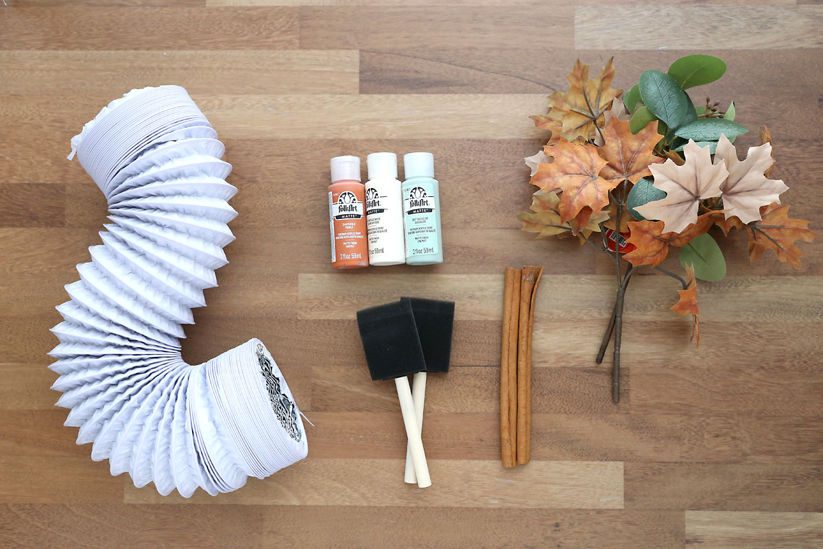 Dryer vent, acrylic paint, foam paintbrushes, cinnamon sticks, faux leaves.