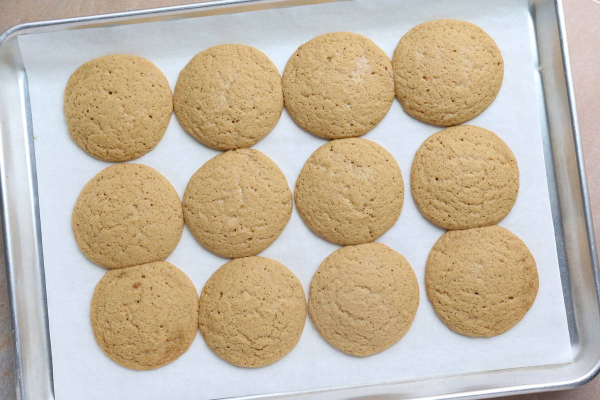 Cookies straight out of the oven, puffed and cracked on top.