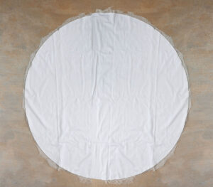 Cutting circle of cheesecloth.