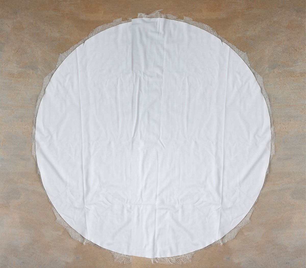 Cutting circle of cheesecloth.