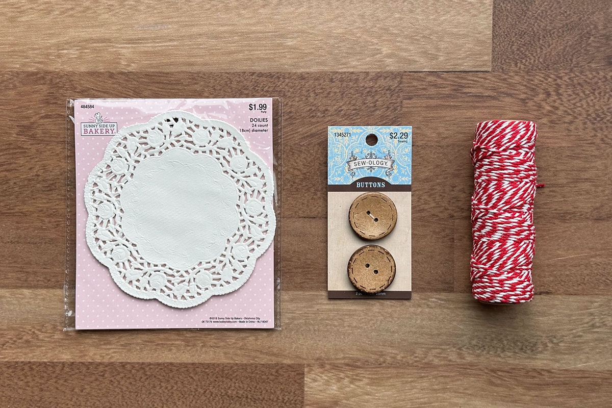 Small paper doilies, buttons, twine.