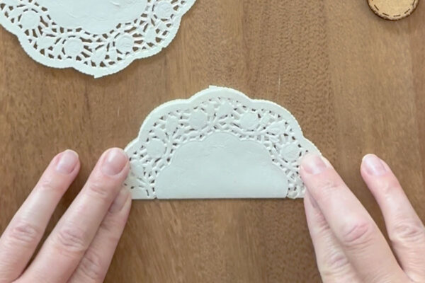 Folding one doily set in half.