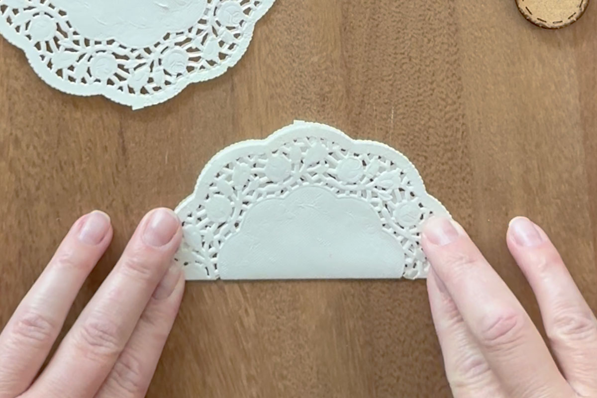 Folding one doily set in half.