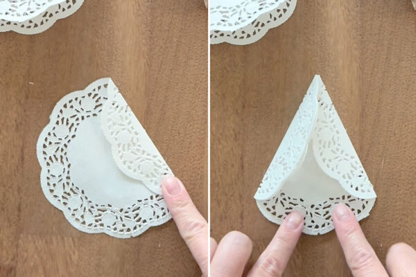 Folding the other doily into a triangle.