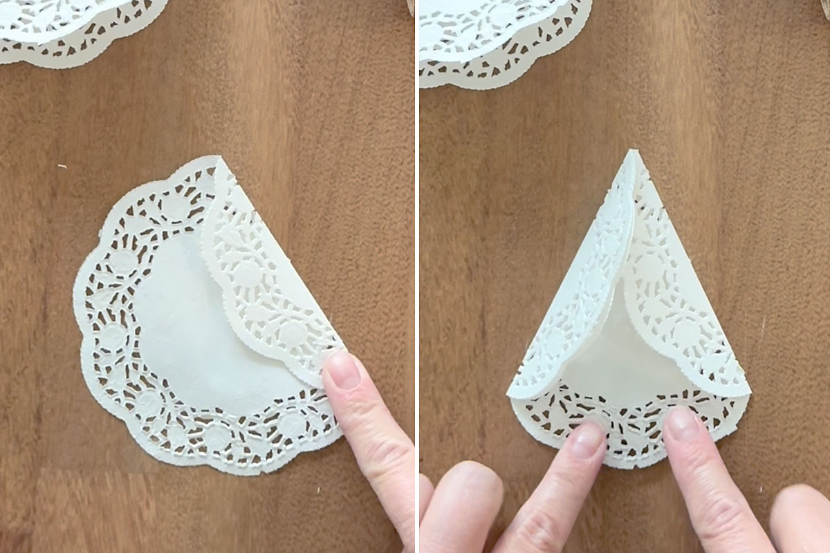 Folding the other doily into a triangle.