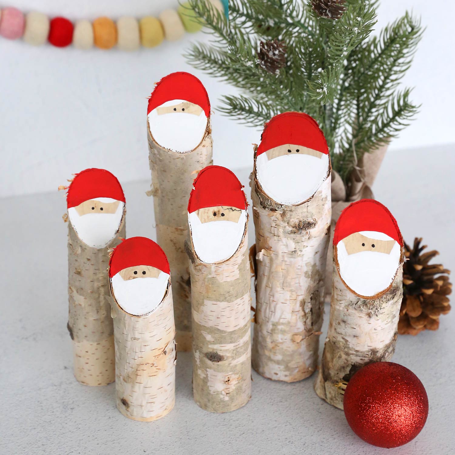 Santas made from small logs.