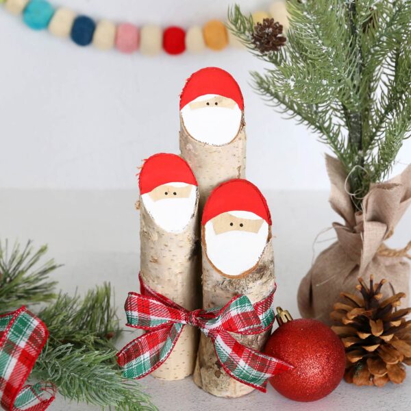 Three log Santas tied with a ribbon.