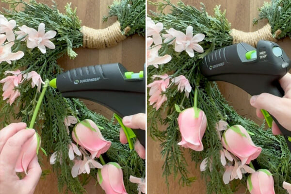 Gluing roses and flowers down on wreath.