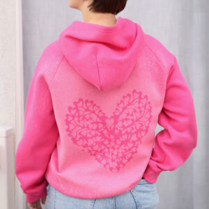 Girl wearing sweatshirt with bleach dyed heart on back.