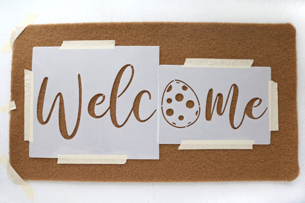 Stencil taped to doormat.