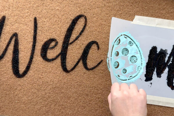 Pulling off the stencil.