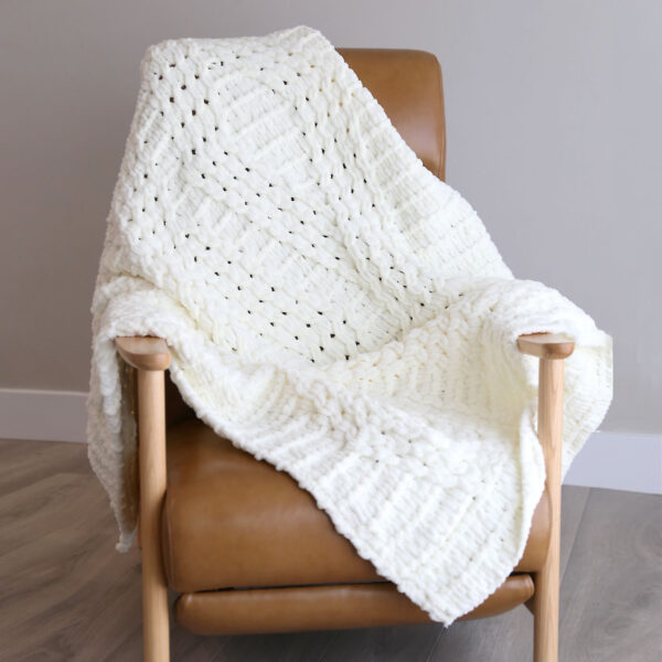 Twisted stitch EZ blanket on a chair.