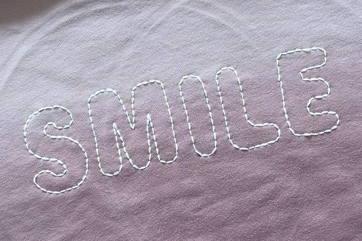 All letters outlined in embroidery.