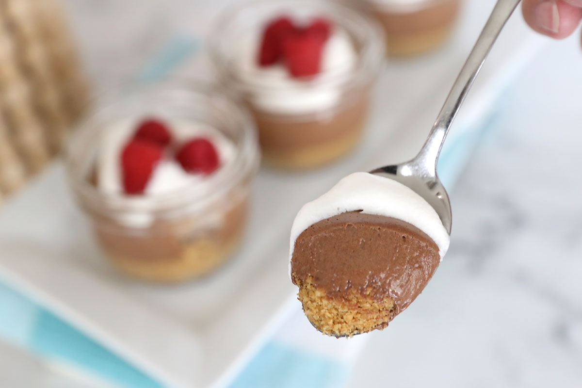 Bite of chocolate cream pie on a spoon.