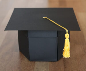 Box folded up to look like a graduation cap.