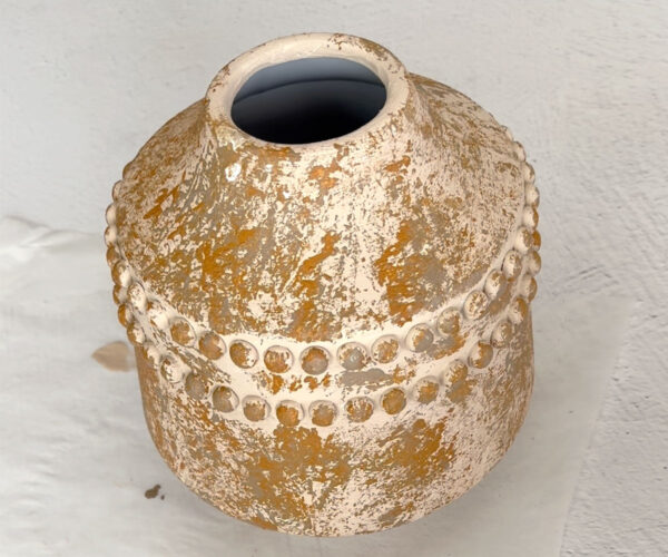 Vase with splotches of darker color.