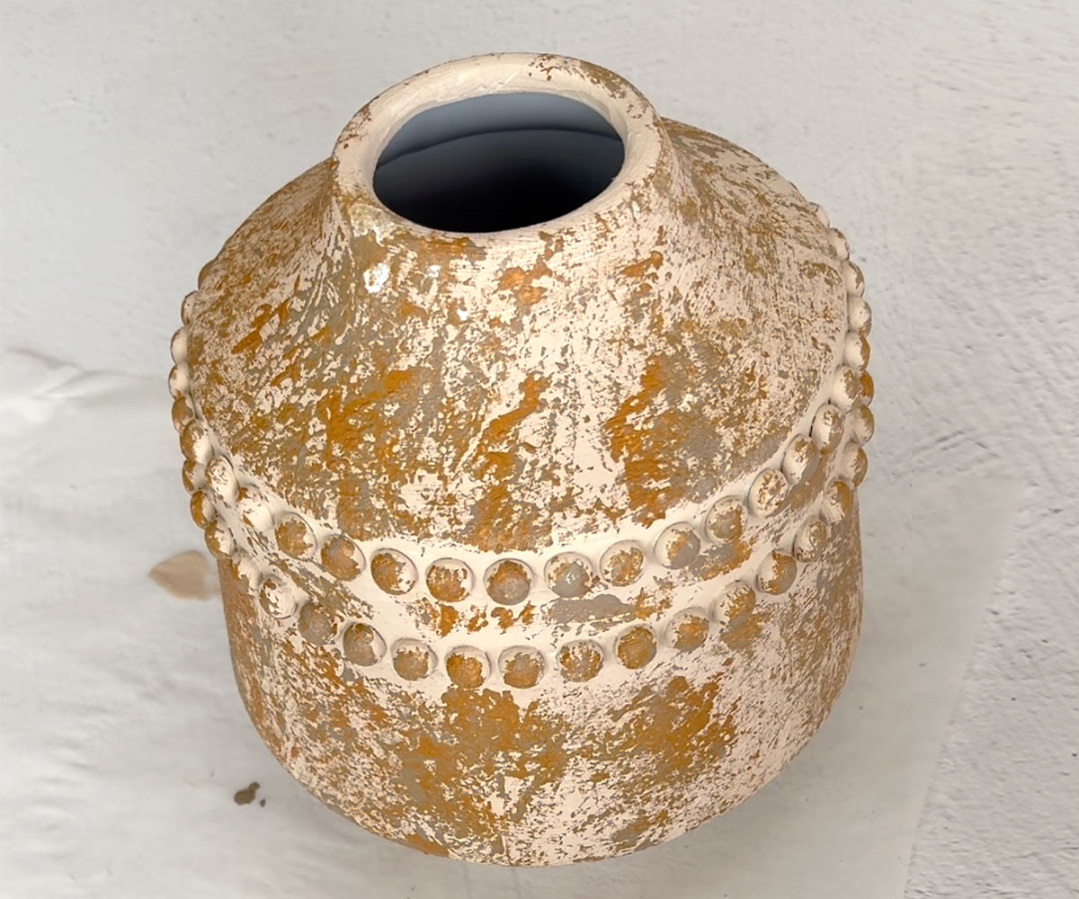 Vase with splotches of darker color.