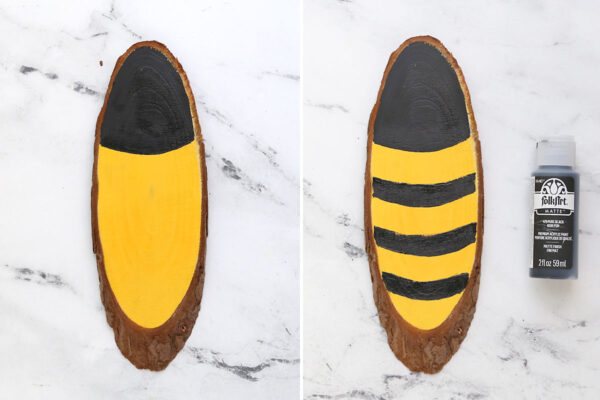 Yellow wood slice painted with black to look like bee.