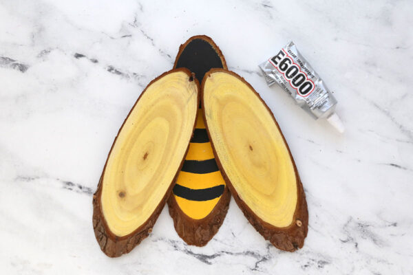 Wood slices glued together in bee shape.