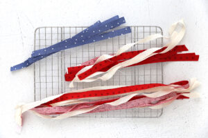 Shorter strips of blue, red, and white fabric; longer strips of red and white fabric.