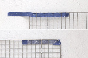Weaving blue strip in and out of cooling rack; folding over and gluing.
