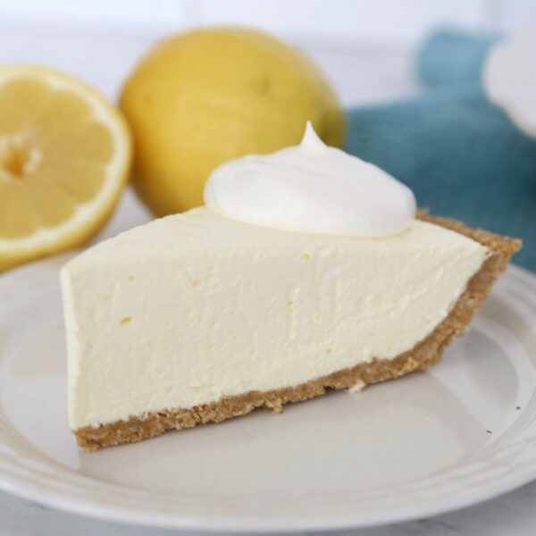 Slice of creamy lemon jell-o pie on a plate.