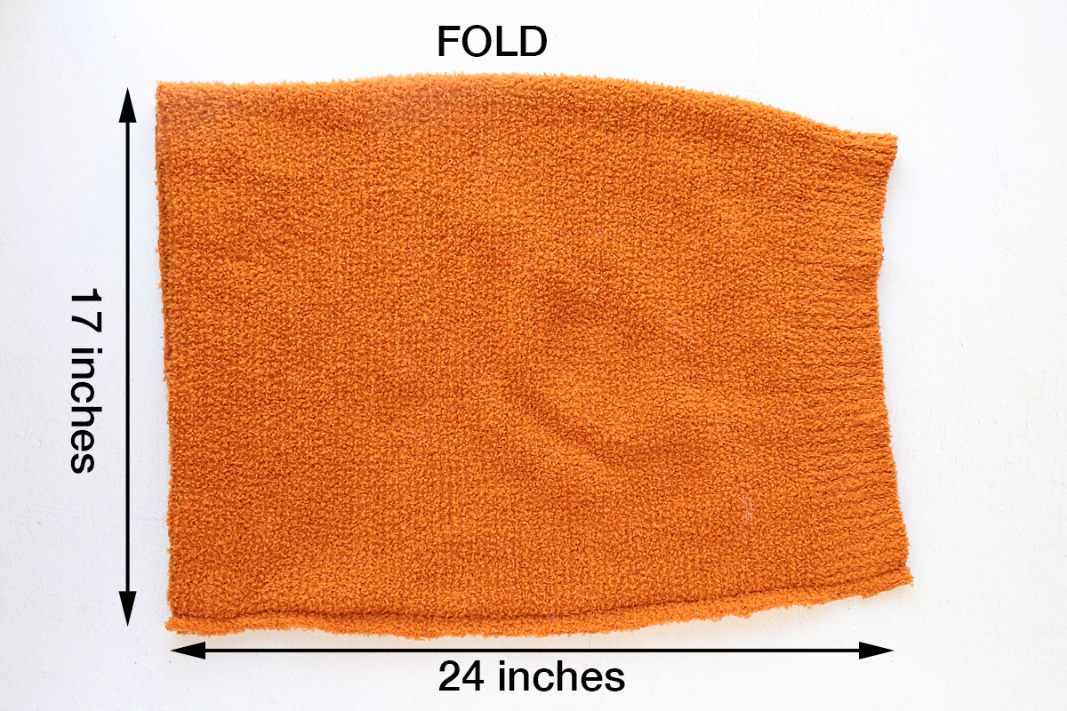 Fold fabric in half and sew down one long side to create tube.