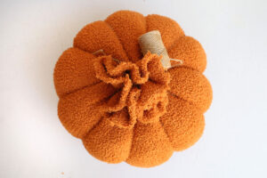 Loop twine around ball to create pumpkin shape.
