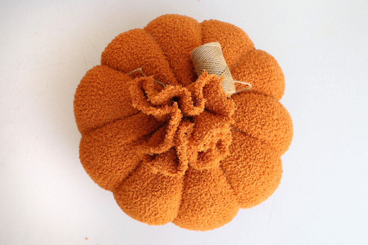 Loop twine around ball to create pumpkin shape.