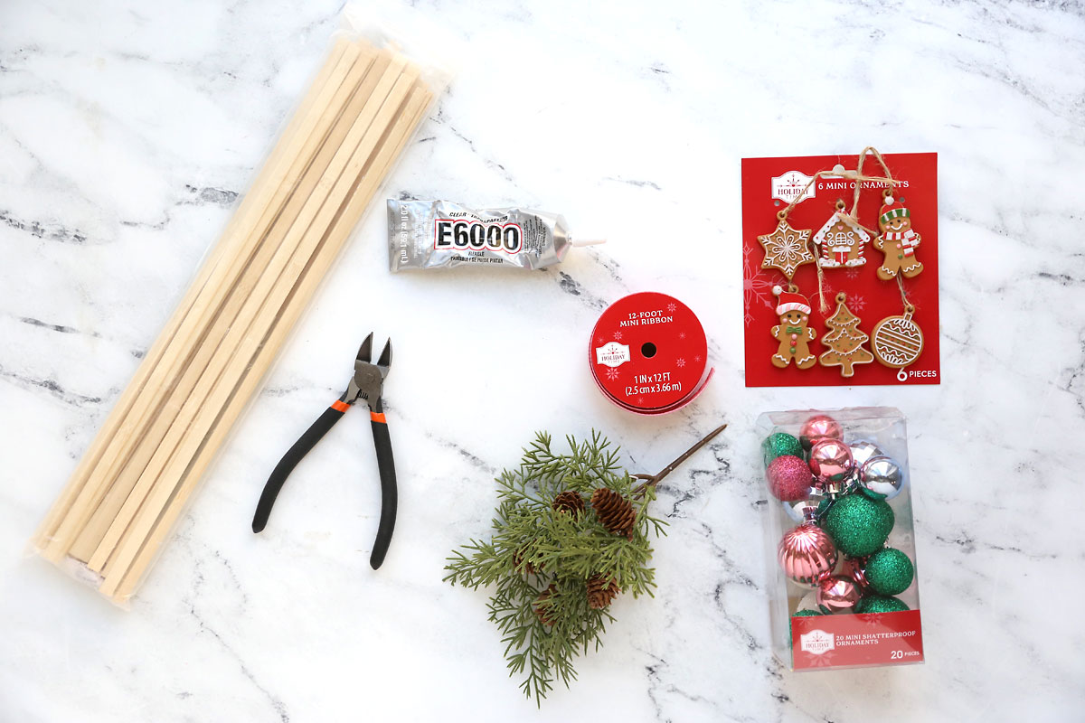 Bamboo strips, wire cutters, E6000, ribbon, mini ornaments, faux greenery.